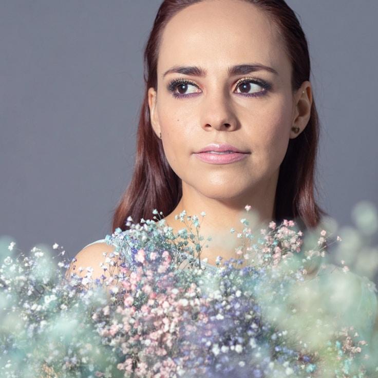 Aria Singh, Lead Design Curator at Adaptive Wellness Design, reviewing corporate floral arrangements